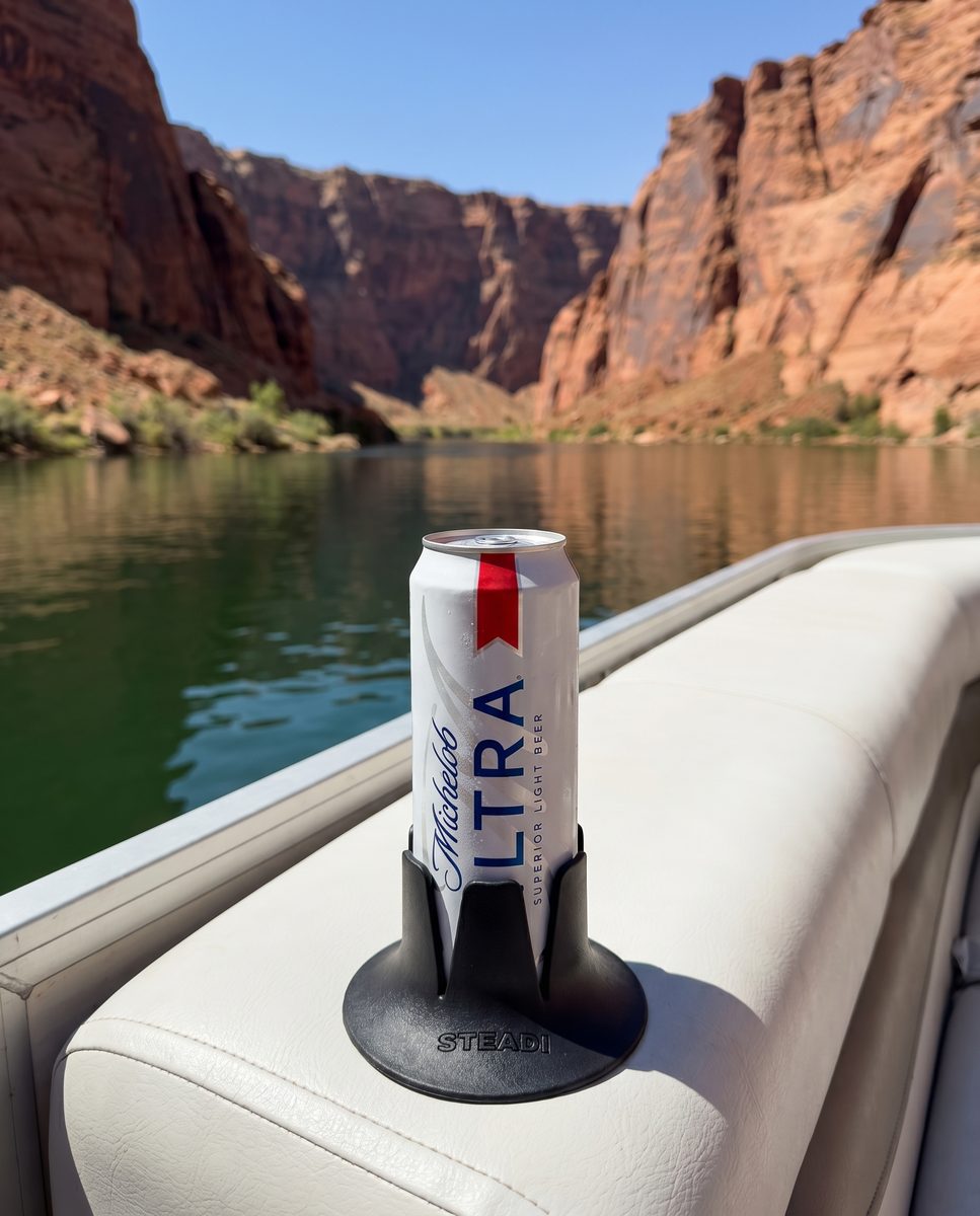 A can standing in a black Steadi on a boat, open water and canyon walls behind it.